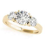 Gold ring with three diamonds on a white background