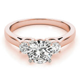 Rose gold ring with a large diamond and smaller diamonds on the sides against a white background