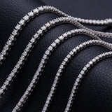 Diamond tennis bracelets on a black leather surface