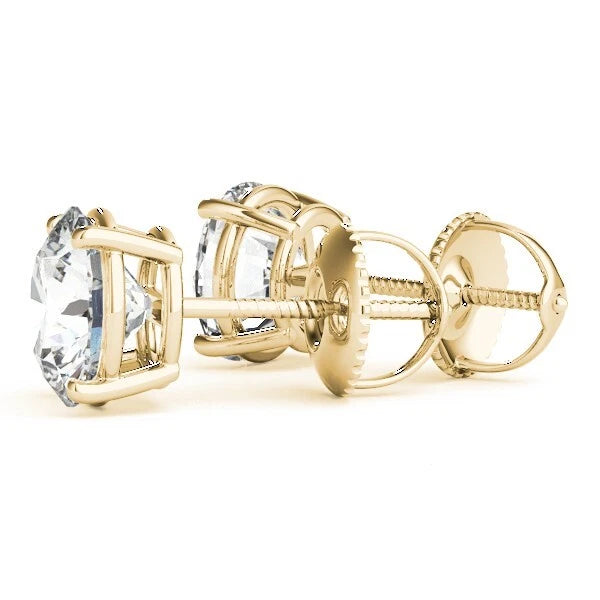 Gold earrings with clear gemstones on a white background