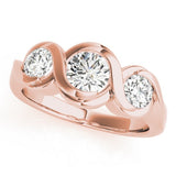 Rose gold ring with three diamonds on a white background