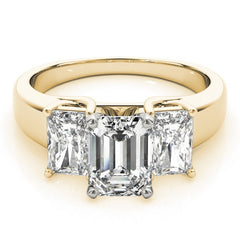 Gold ring with three emerald-cut diamonds on a white background