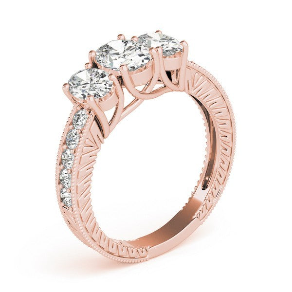 Rose gold ring with three clear gemstones on a white background