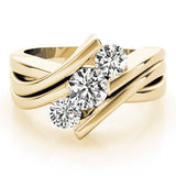 Gold ring with three diamonds on a light background