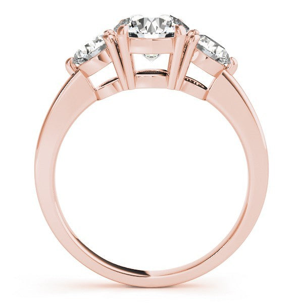 Rose gold ring with three diamonds on a white background