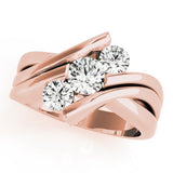 Rose gold ring with three diamonds on a white background
