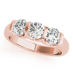 Rose gold ring with three diamonds on a white background