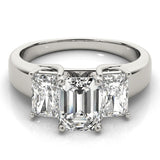 Diamond ring with three rectangular-cut diamonds on a white background