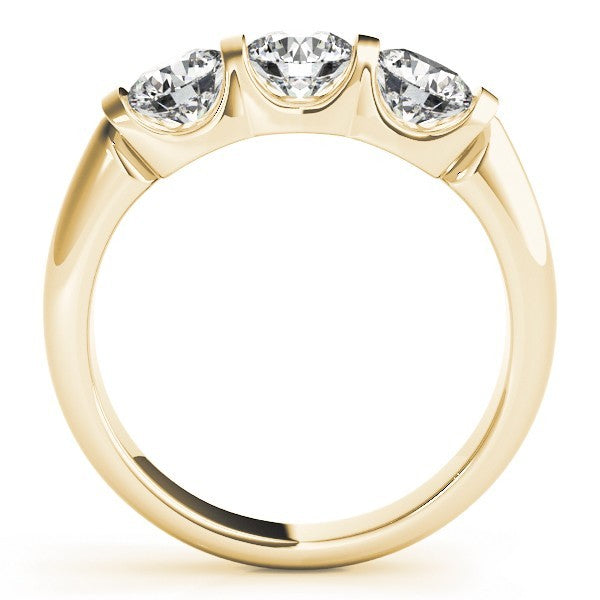 Gold ring with three clear gemstones on a white background