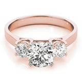 Rose gold ring with three diamonds on a white background
