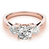 Rose gold ring with three diamonds on a white background