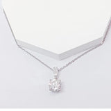 A solitaire round natural diamond pendant necklace in platinum, displayed against a white background.