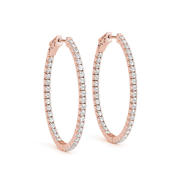 Rose gold hoop earrings with clear gemstones on a white background