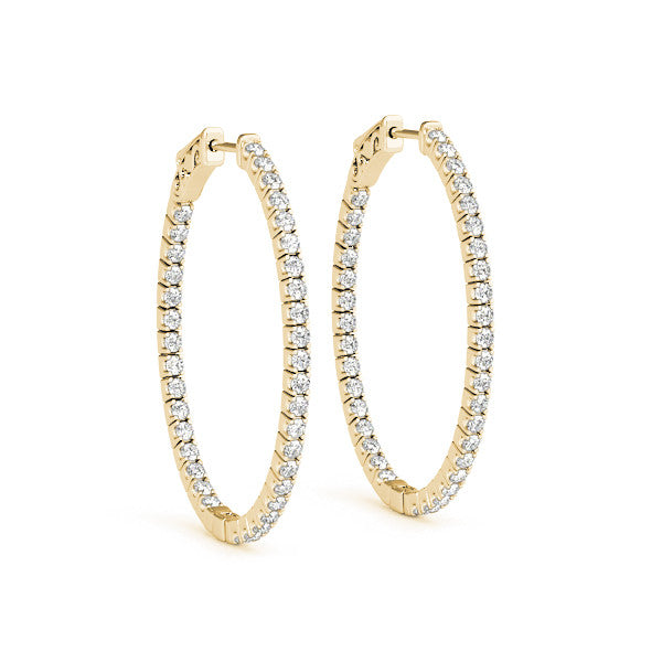 Gold hoop earrings with clear gemstones on a white background