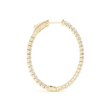 Gold hoop earring with embedded diamonds on a white background