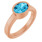 Oval Aquamarine Solitaire Ring in Gold and Platinum