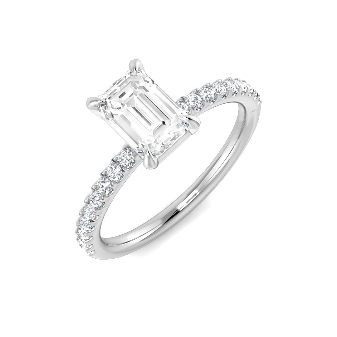 Top-down view of an 18K white gold engagement ring featuring a central emerald-cut lab-grown diamond.
