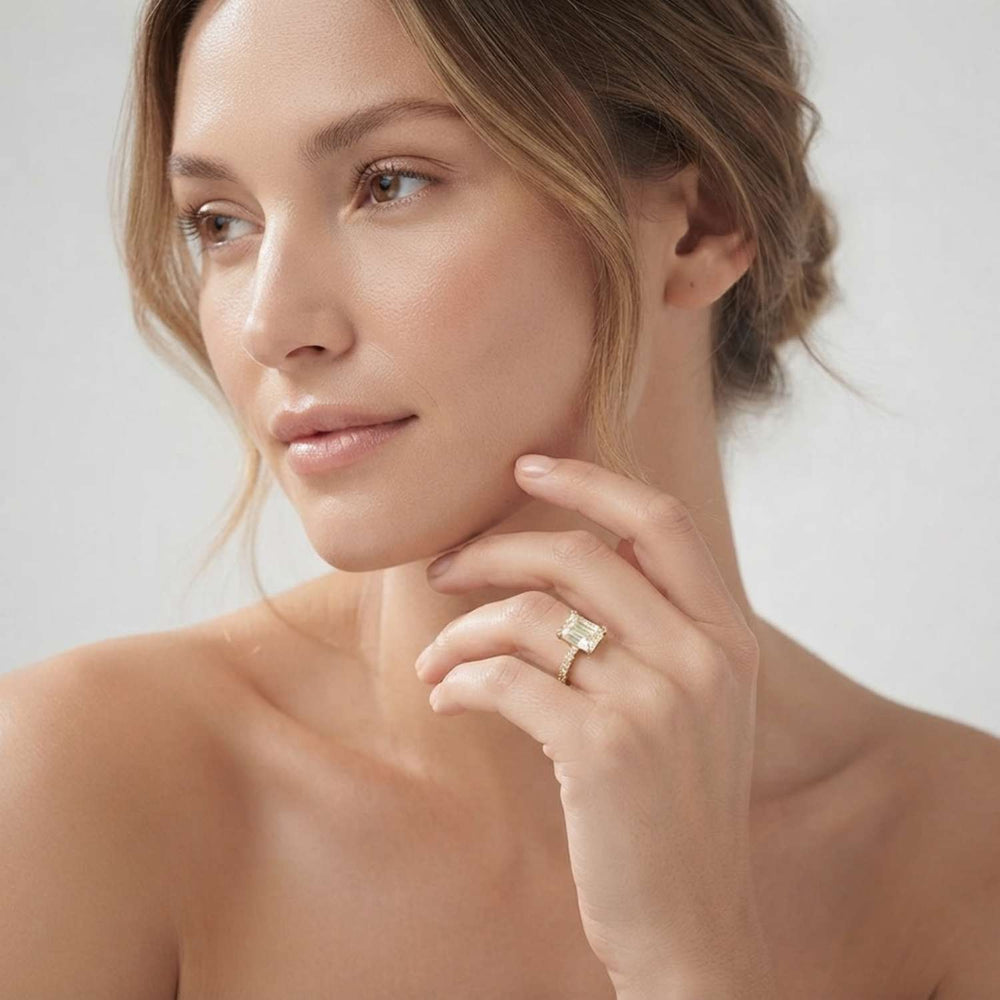 Side profile view of a prong-set emerald-cut lab diamond engagement ring showcasing fine craftsmanship.