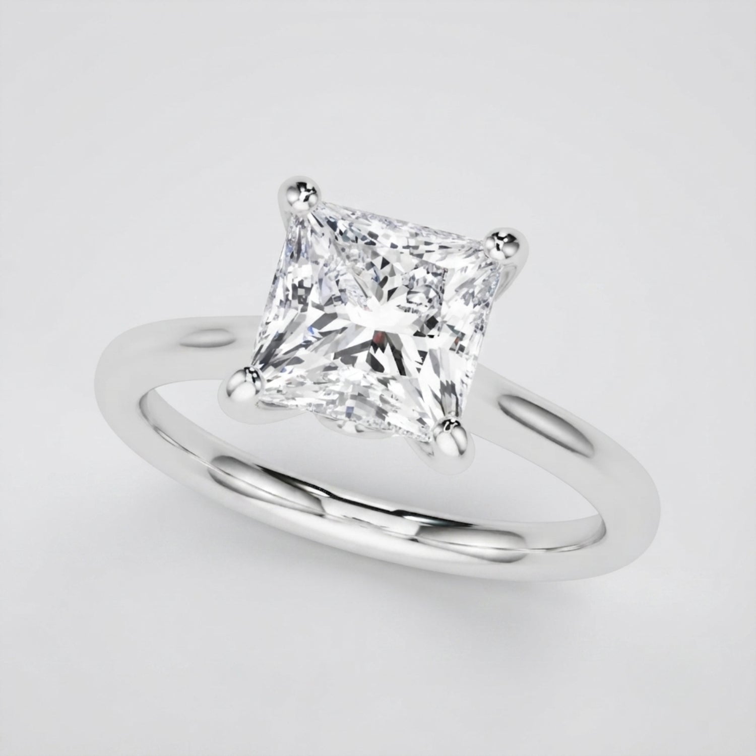 Elegant 18K white gold princess-cut diamond solitaire ring showcasing D color and VVS clarity.