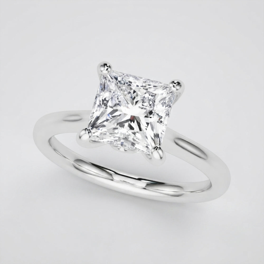 Elegant 18K white gold princess-cut diamond solitaire ring showcasing D color and VVS clarity.