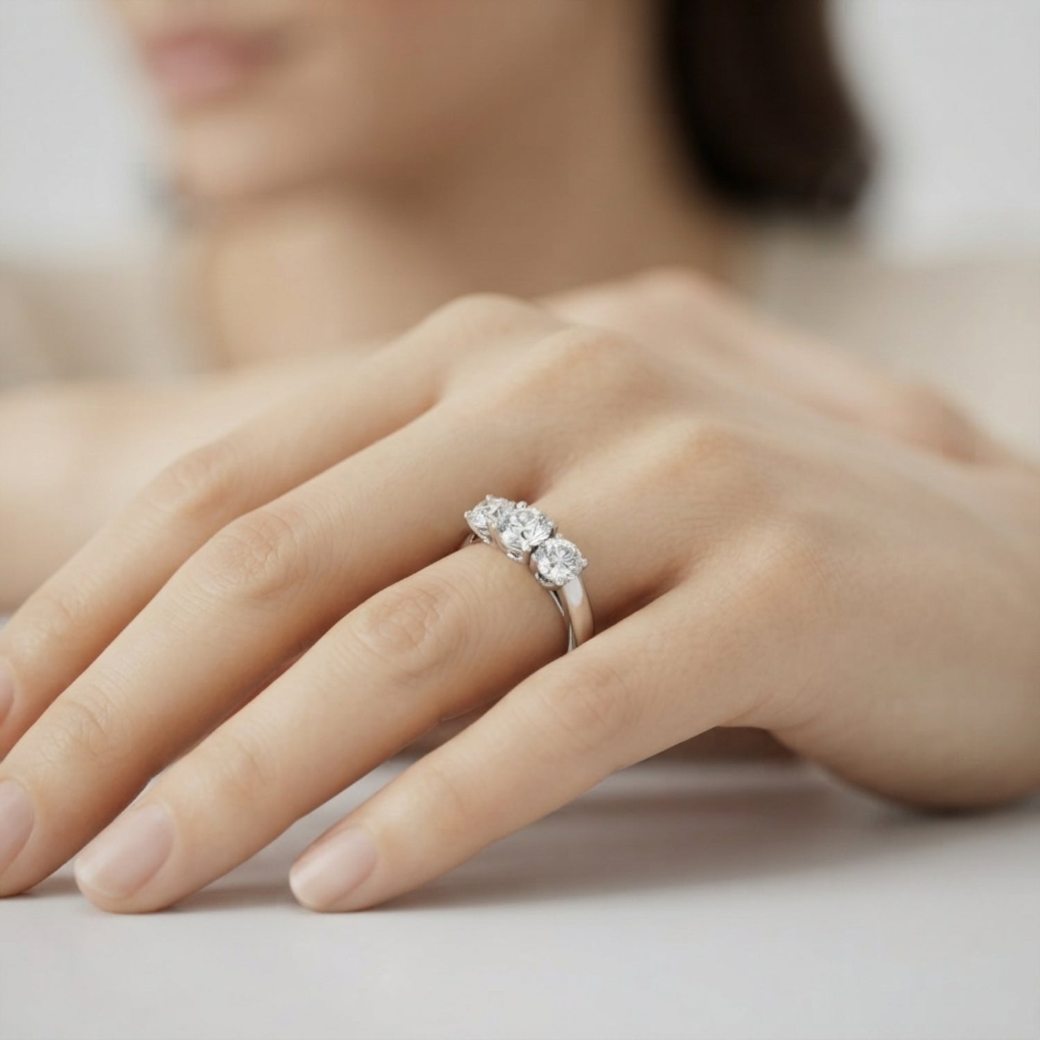 Elegant 18K white gold round diamond 3-stone engagement ring with secure prong settings.