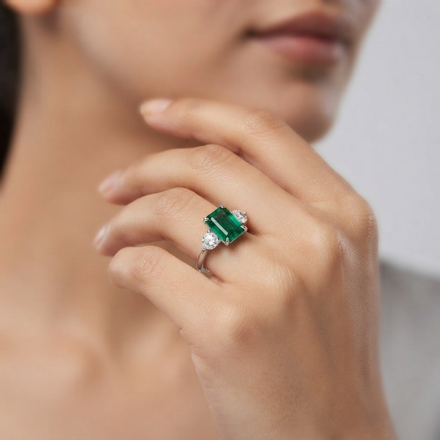 Emerald Trilogy Ring with Round Diamond Side Stones | Three Stone Ring