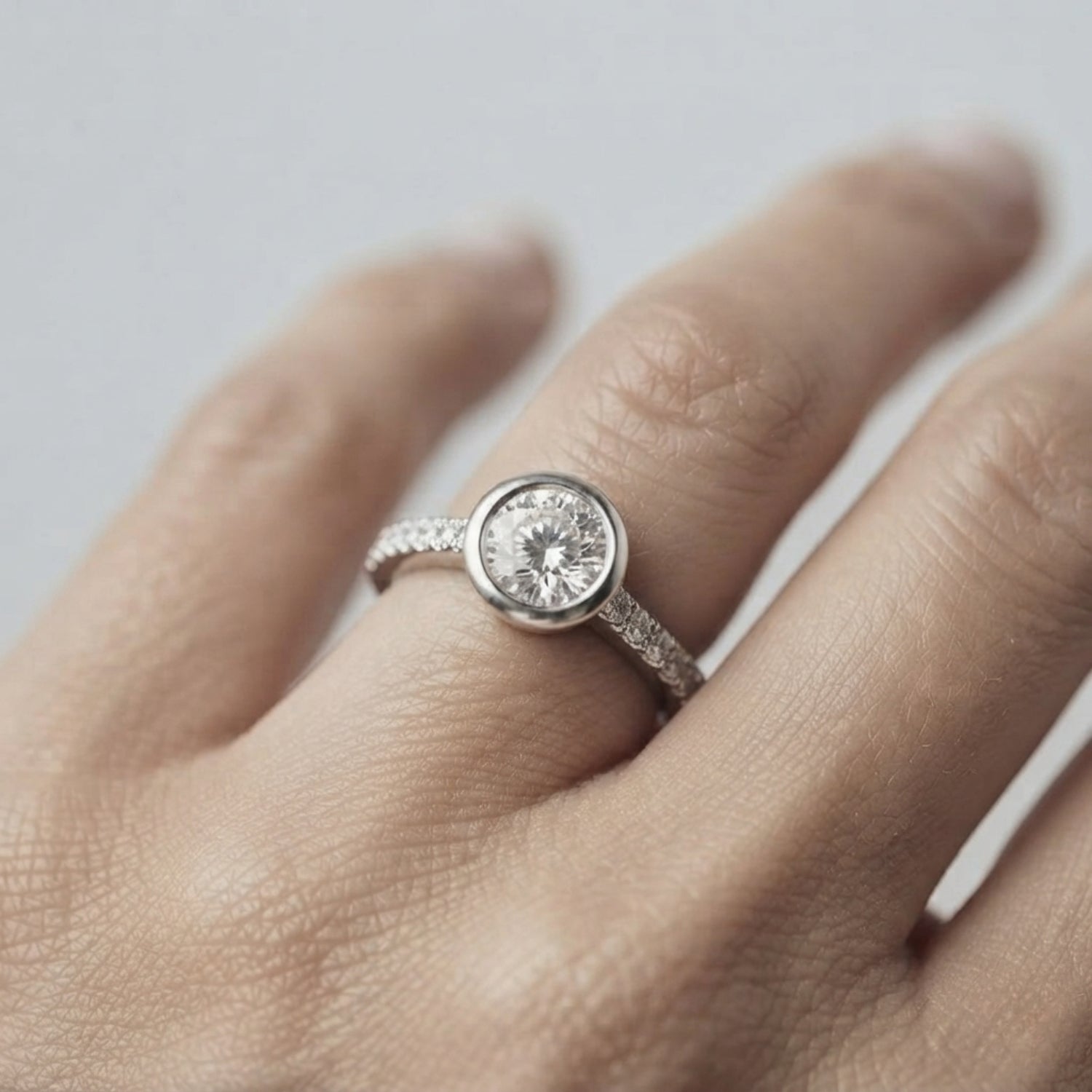Round Diamond Bezel Set Solitaire Ring with Pavé Band in White Gold