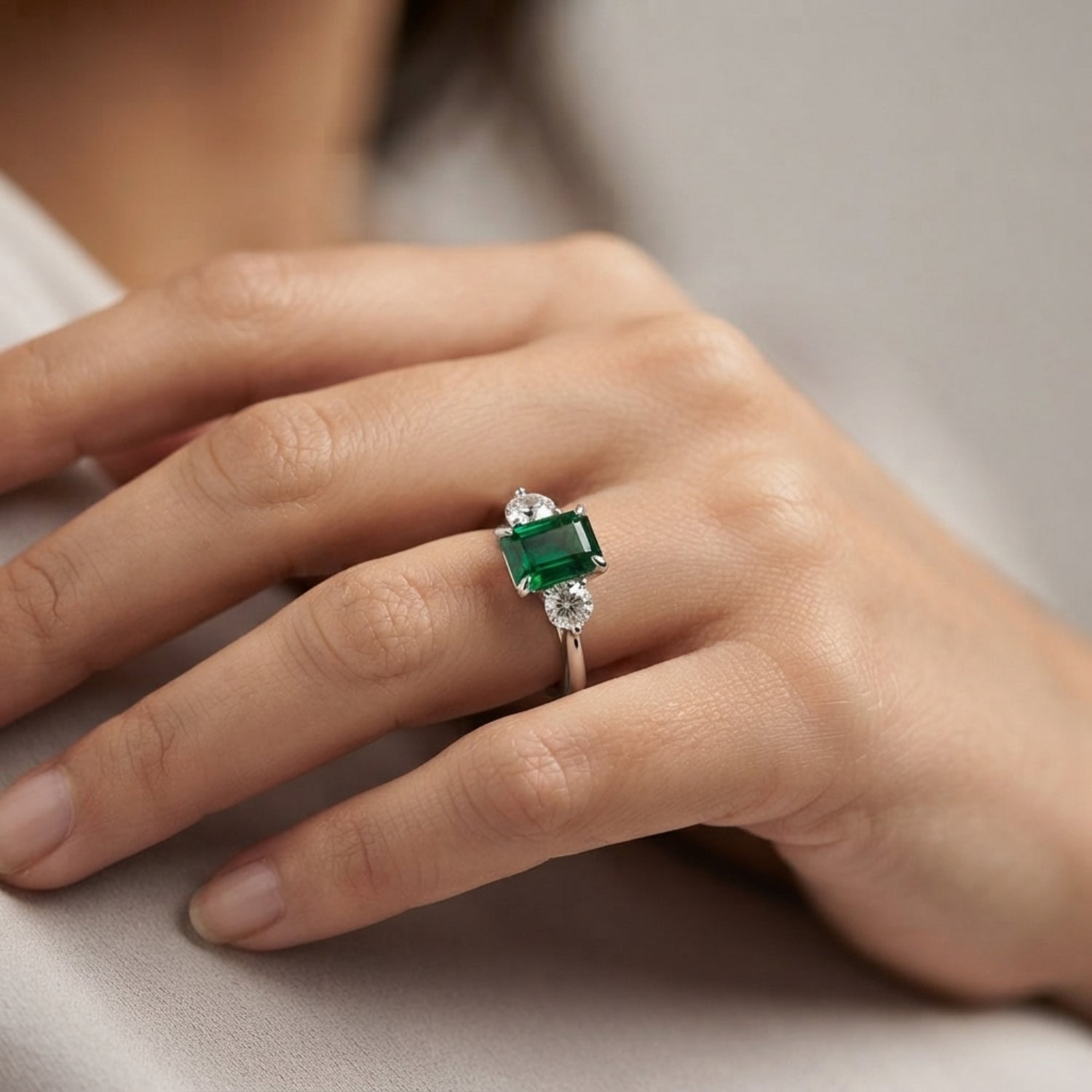 Emerald Trilogy Ring with Round Diamond Side Stones | Three Stone Ring