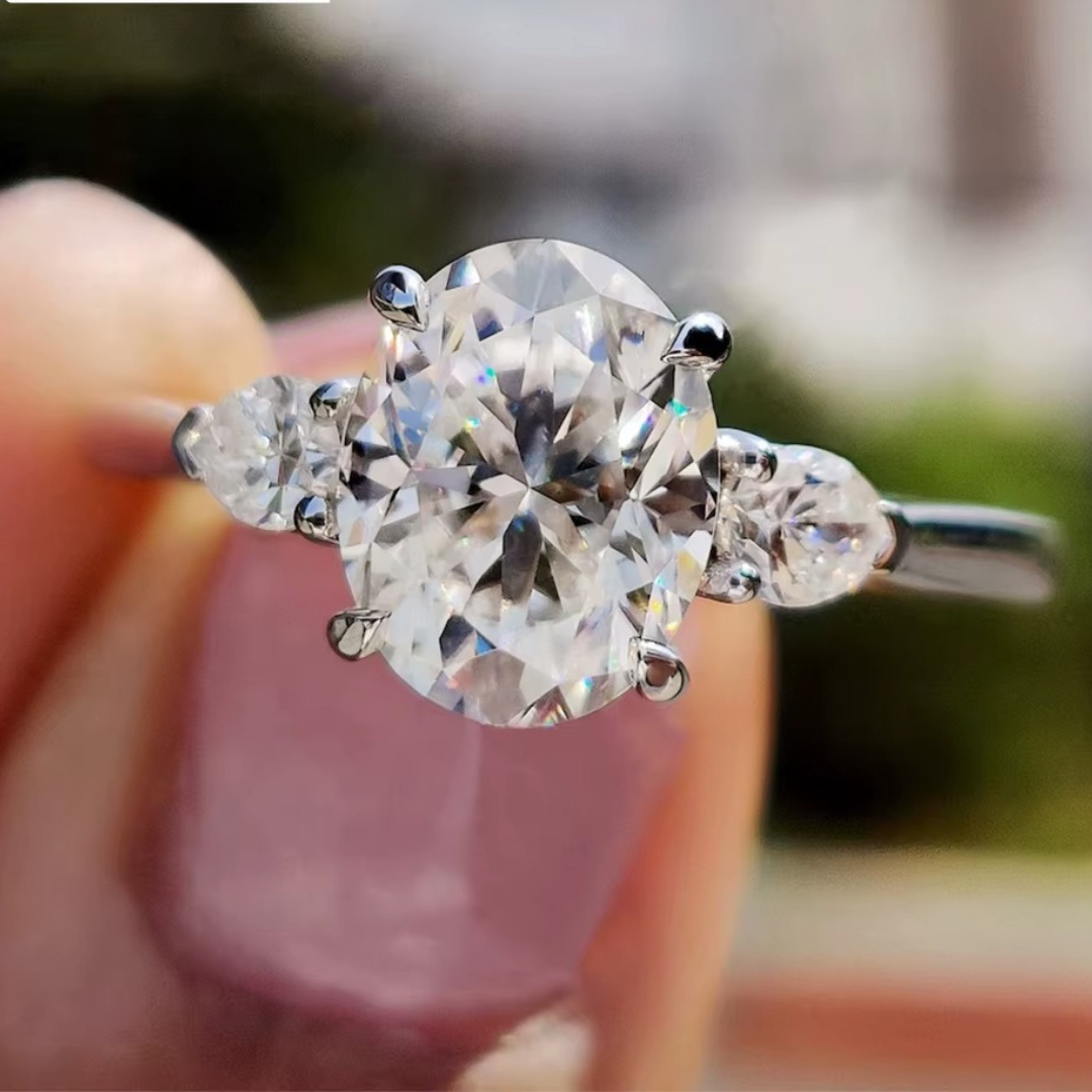 Oval Diamond and Pear Diamond Three Stone Engagement Ring