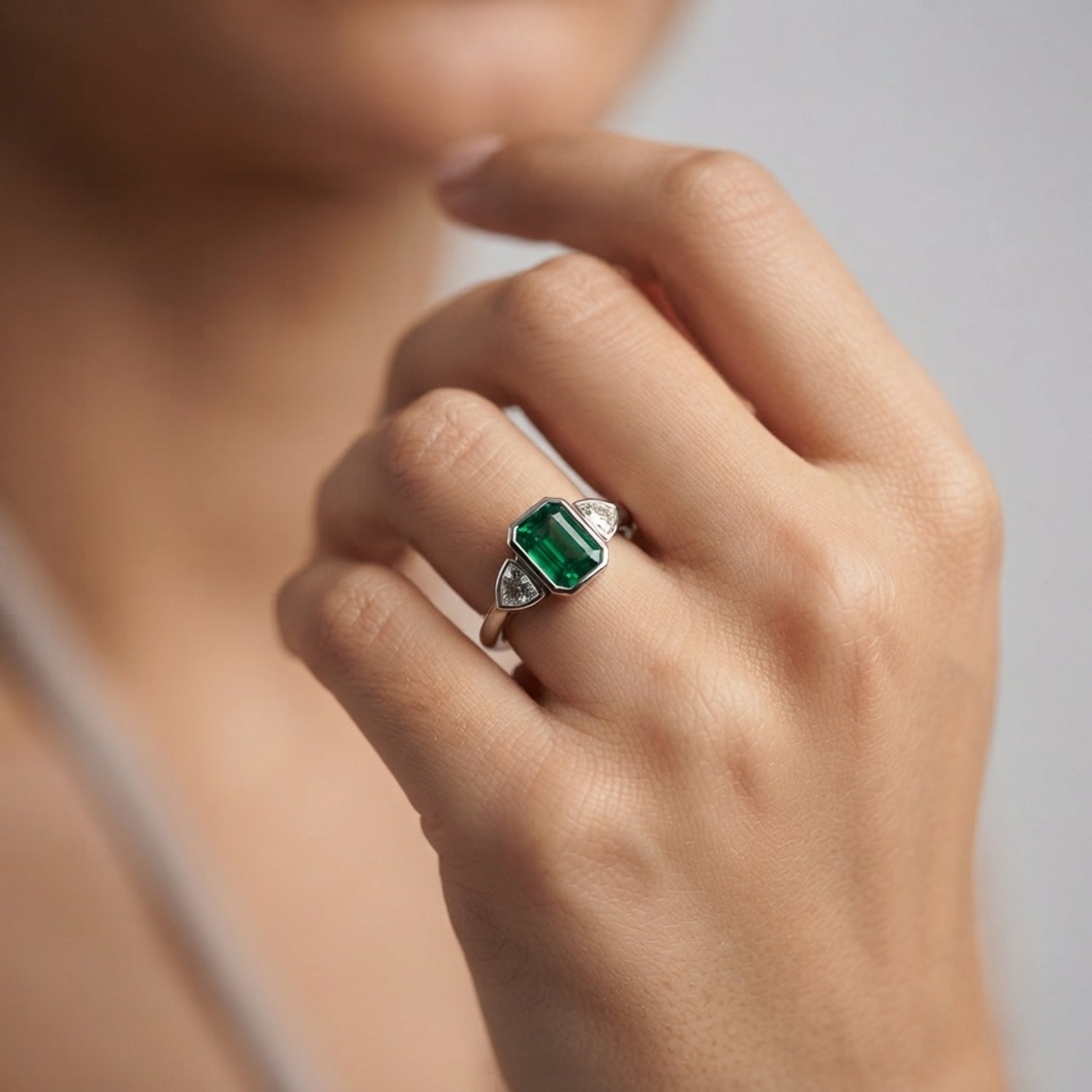 Emerald Cut Green Emerald Three Stone Ring with Trillion Diamond Side Stones | Bezel Set