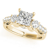 Gold ring with a central diamond and smaller diamonds on a white background