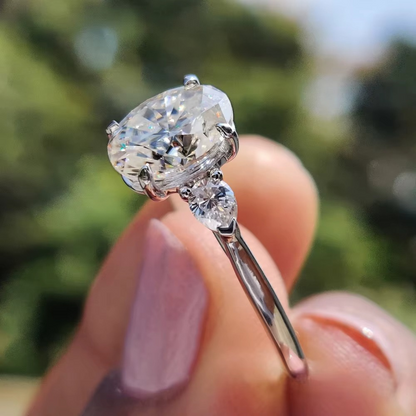 Oval Diamond and Pear Diamond Three Stone Engagement Ring