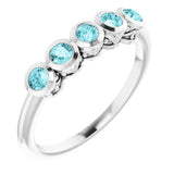 Round Blue Zircon Accented Ring in Gold and Platinum