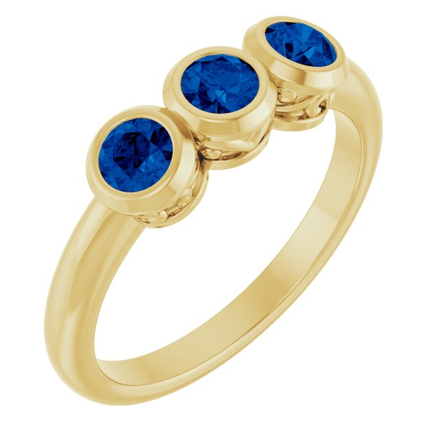 Round Blue Sapphire Three Stone Ring in Yellow Gold