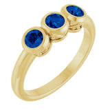 Round Lab-Grown Blue Sapphire Three Stone Ring in Yellow Gold