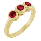 Round Lab-Grown Ruby Three Stone Ring in Yellow Gold