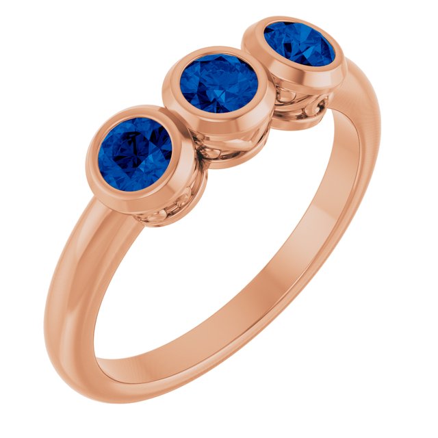 Round Lab-Grown Blue Sapphire Three Stone Ring in Rose Gold