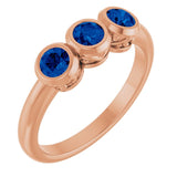 Round Lab-Grown Blue Sapphire Three Stone Ring in Rose Gold