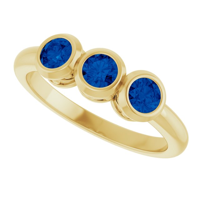 Round Blue Sapphire Three Stone Ring in Yellow Gold