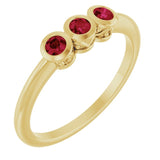 Round Ruby Three Stone Ring in Yellow Gold
