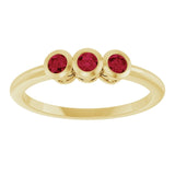 Round Ruby Three Stone Ring in Yellow Gold