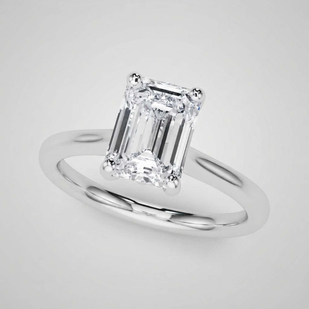 Classic 9K yellow gold emerald-cut solitaire engagement ring highlighting timeless craftsmanship.