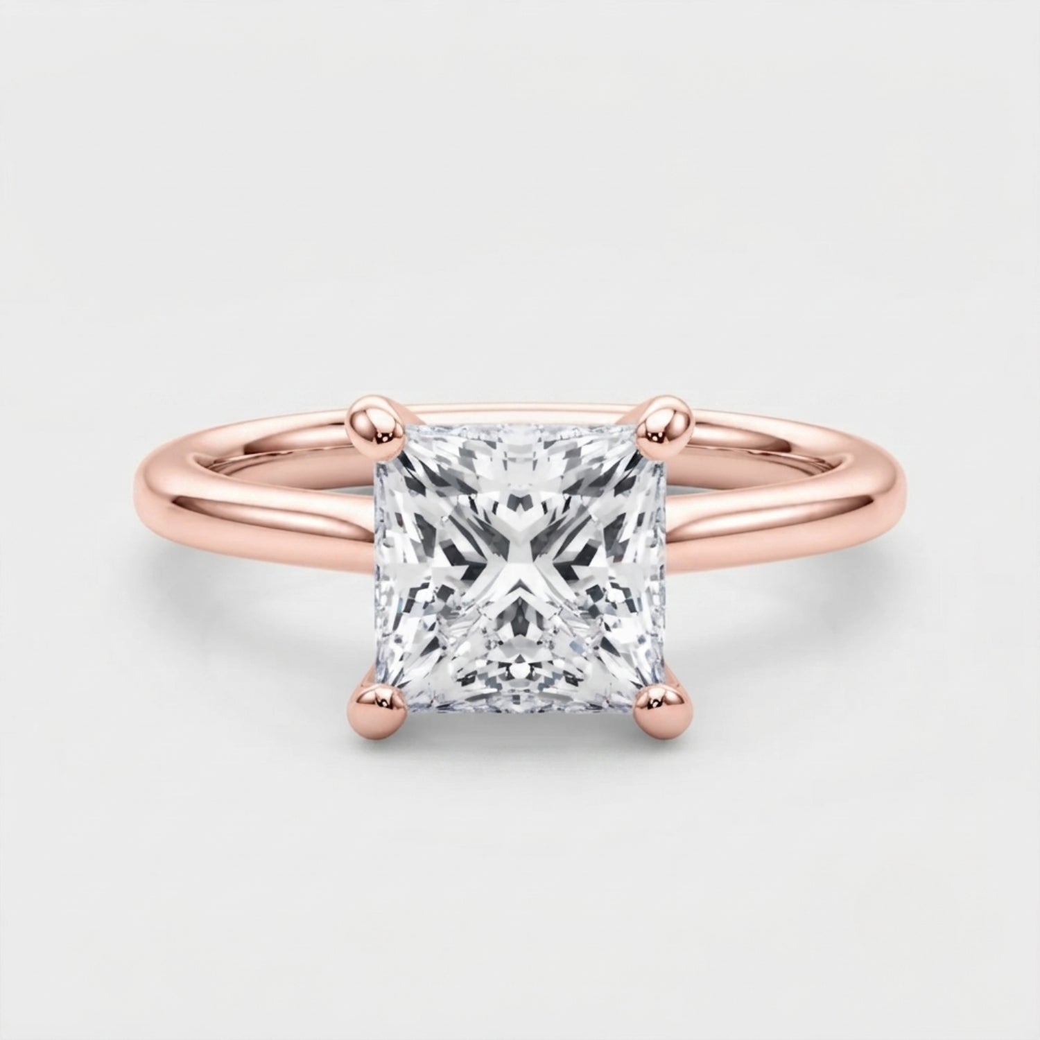 Classic 9K yellow gold princess-cut solitaire engagement ring on a clean neutral background.