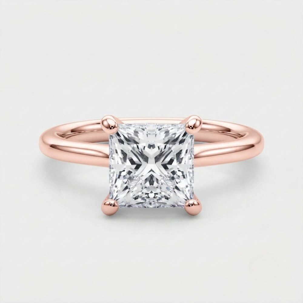 Classic 9K yellow gold princess-cut solitaire engagement ring on a clean neutral background.