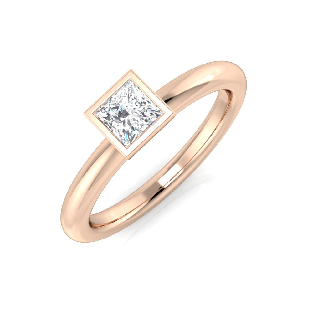 Rose gold ring with a diamond on a white background