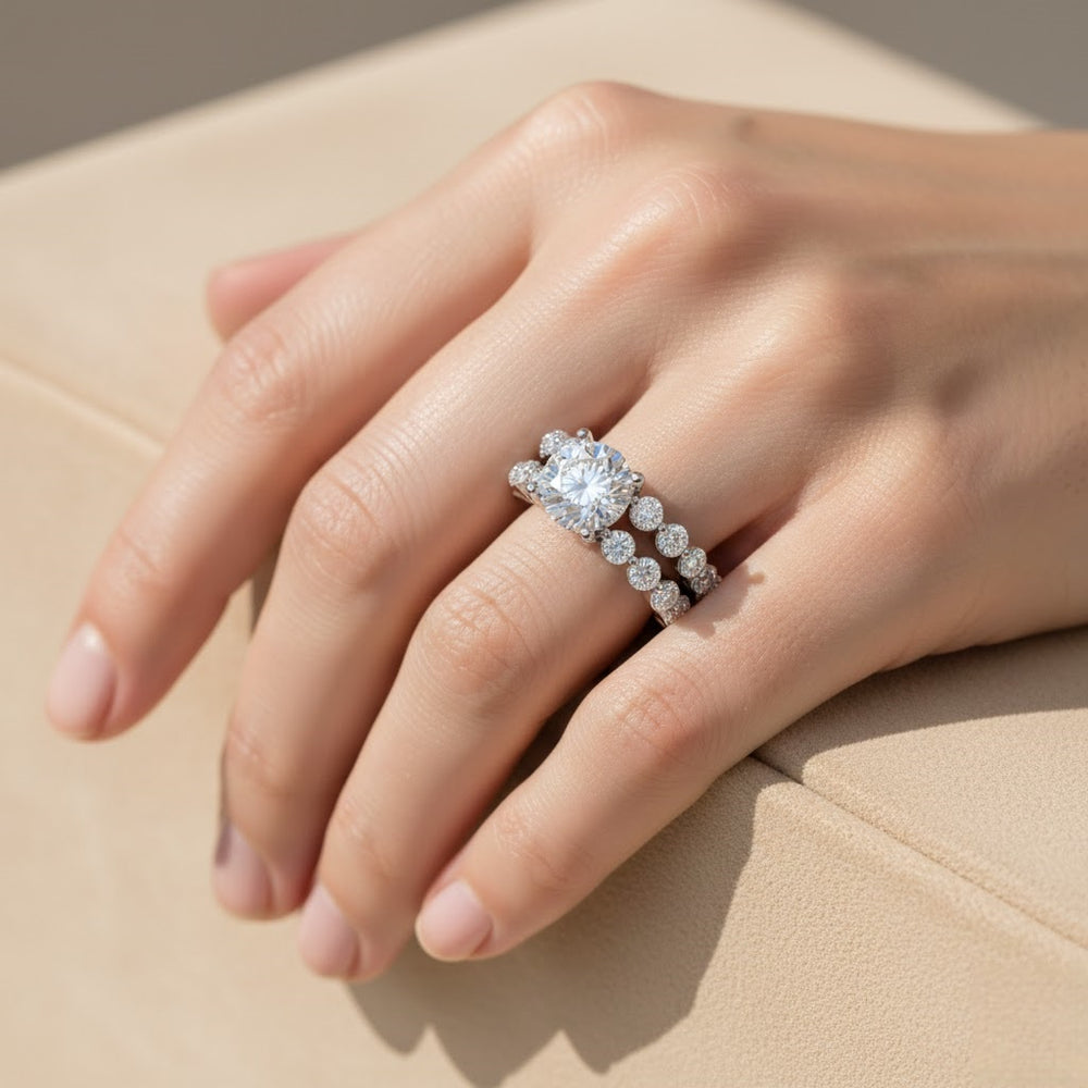 Close-up of a hand wearing a diamond ring on a beige surface