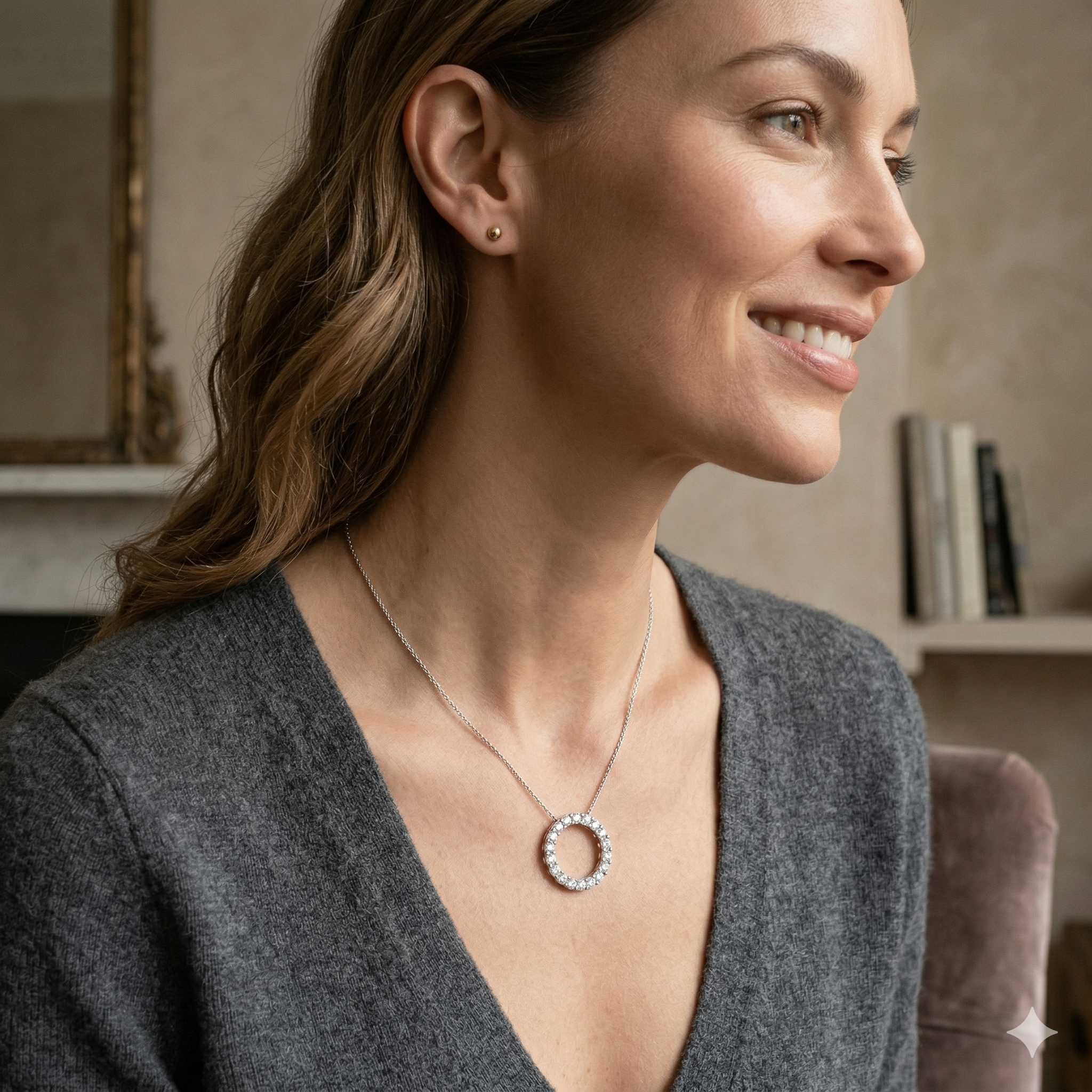 Woman wearing a necklace with a circular pendant in a cozy indoor setting