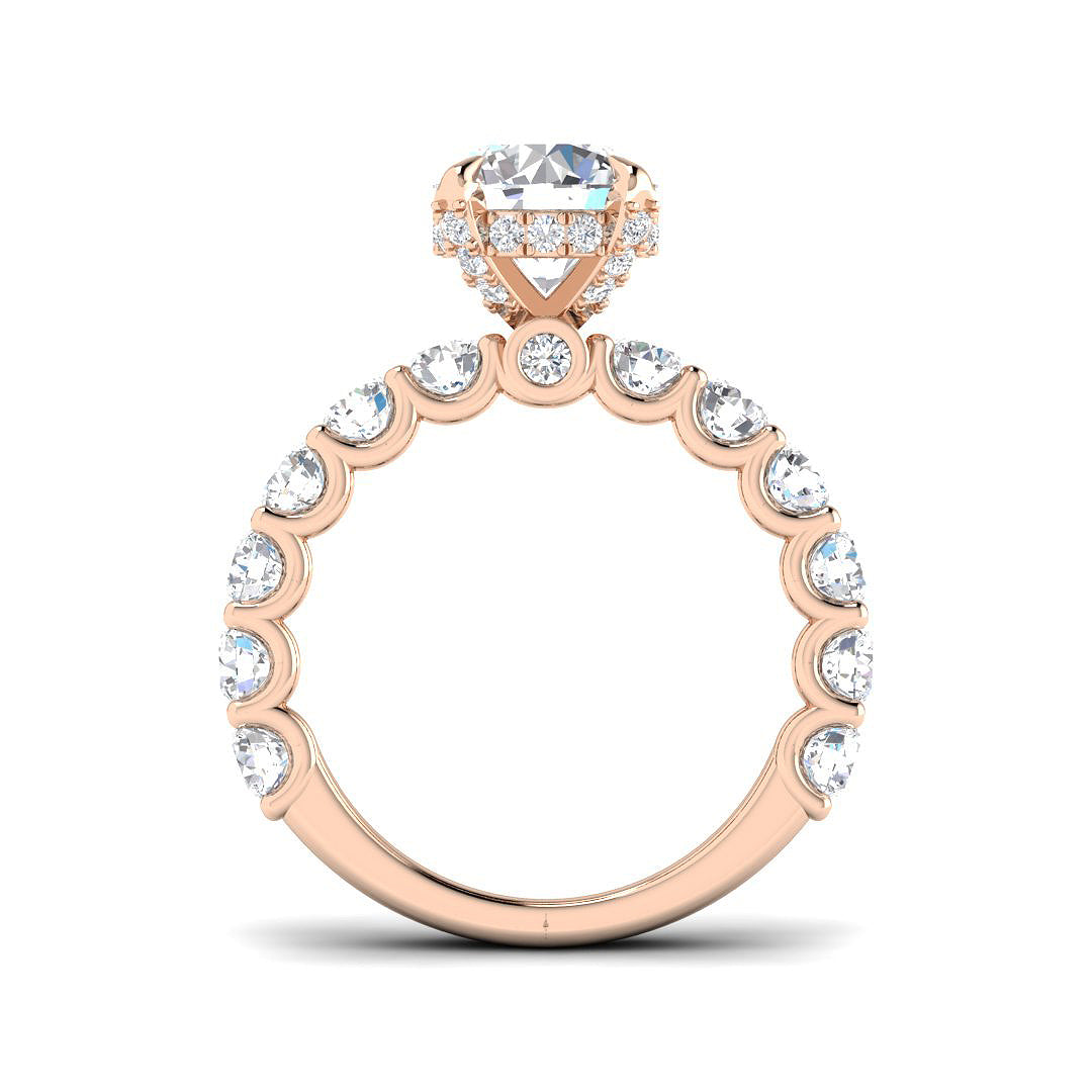 Rose gold ring with a large central gemstone and smaller stones around on a white background