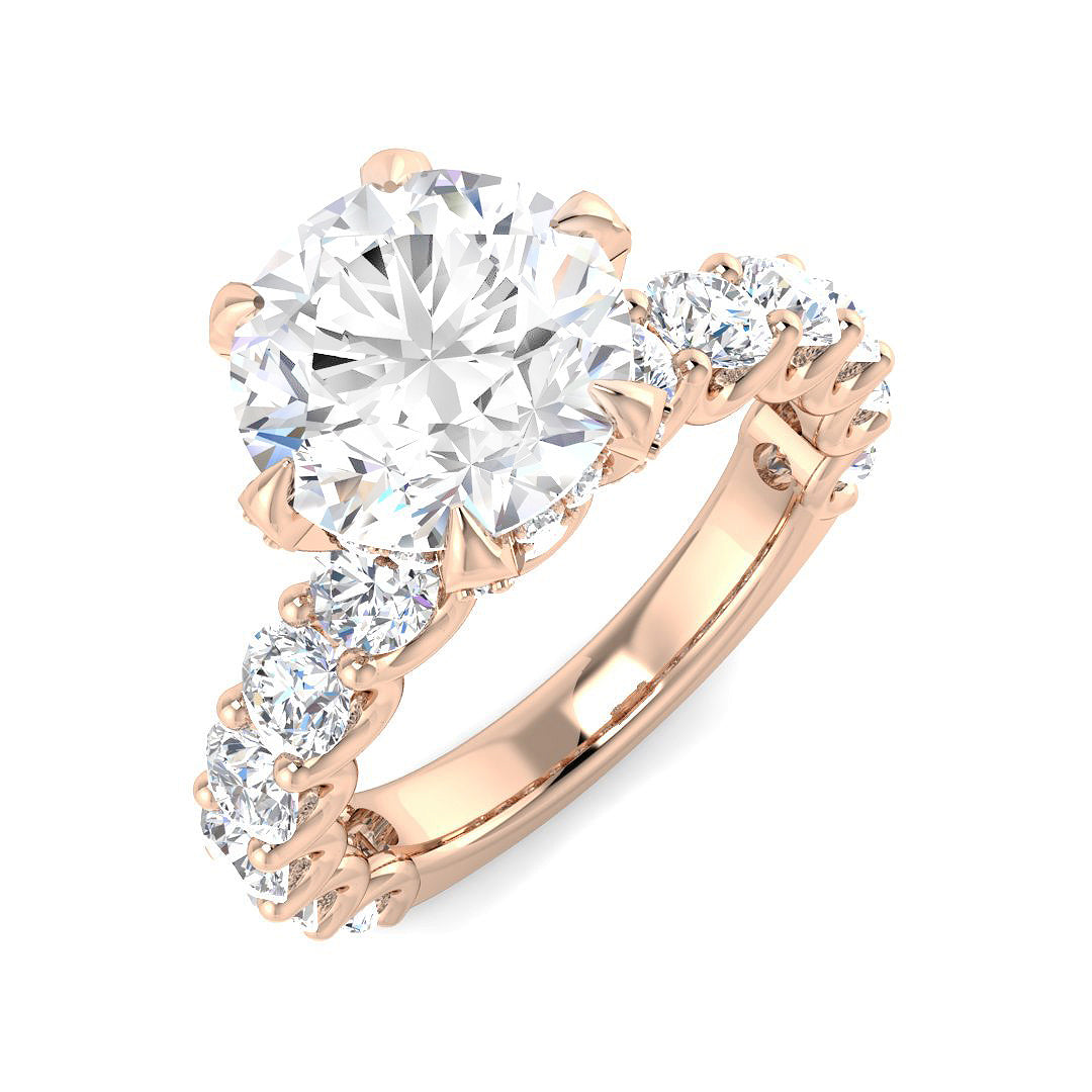 Rose gold ring with a large central diamond and smaller diamonds on the sides against a white background