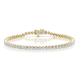 A yellow gold tennis bracelet with a diamond inset in a rub-over setting.